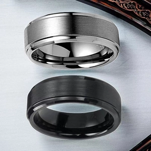 Detailed macro view of brushed titanium steel rings in black and grey finishes