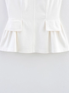 Detail of white pleated sleeveless top with flap pockets and high-quality twill texture