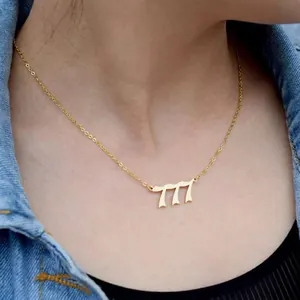Gold stainless steel angel number 777 necklace worn by a model on a cable chain