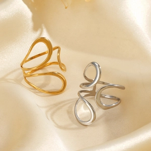 Minimalist hollow line stainless steel rings in gold and silver on silk background