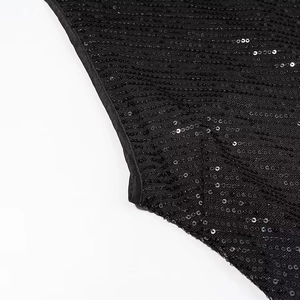 Close-up macro view of the shimmering black sequin fabric detail on party maxi dress
