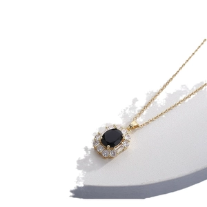 Elegant gold titanium necklace with oval black stone and shimmering zirconia accents