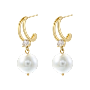 Elegant gold earrings with white rice pearls and sparkling zircons on white background