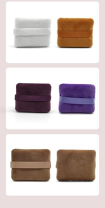 Close-up of square velvet makeup puffs in six different colors with soft ribbon handles