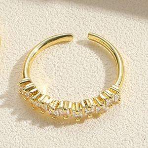 Macro shot of gold adjustable ring featuring a row of sparkling clear zircon stones