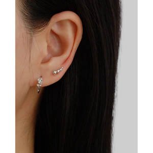Close-up of S925 silver rose flower earrings and leaf ear cuffs on a model's ear