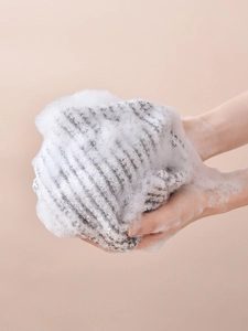 Antibacterial exfoliating back scrubber showing dense foam for deep cleansing effect