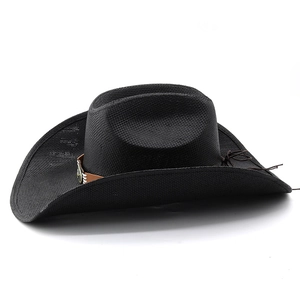 Close-up of black woven cowboy hat with brown leather band and vintage metal badge detail
