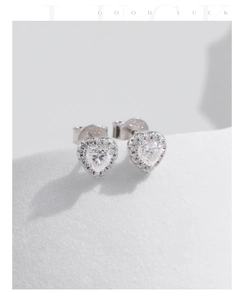 Macro shot of S925 sterling silver heart earrings with sparkling moissanite stones