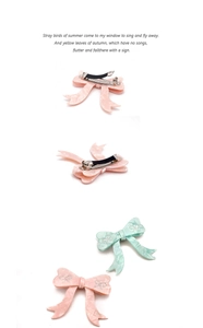 Macro detail of pink and mint green marble acetate bow clips with silver glitter finish