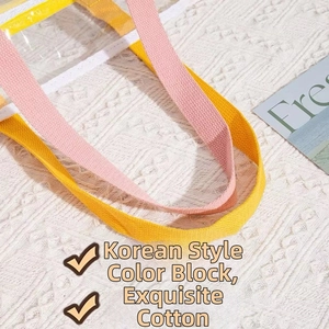 Detail of waterproof PVC beach bag showing yellow and pink cotton ribbon handles