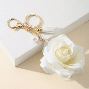 Elegant white rose keychain with white tassel and pearl charm on a gold-plated metal clip