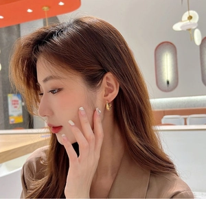 Elegant 18K gold plated twisted hoop earrings for women with a minimalist curved design