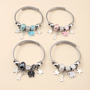 Detail of four bohemian wire bracelets featuring enamel elephant charms and beads