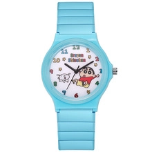 Close-up of sky blue silicone strap and Crayon Shin-chan dial on a kid quartz watch