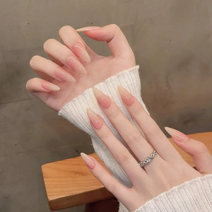 Long almond gradient nude pink press-on nails with silver glitter tips for women