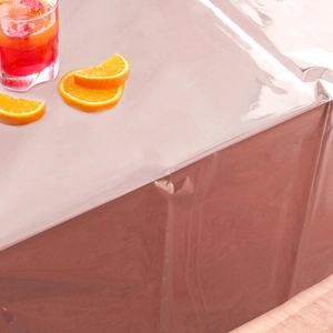 Detail of rose gold foil tablecloth with metallic luster and party scene settings