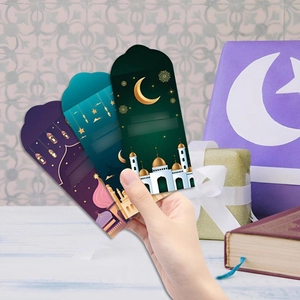 Detail of Eid Mubarak envelopes in purple and green with Islamic patterns and crescent moon
