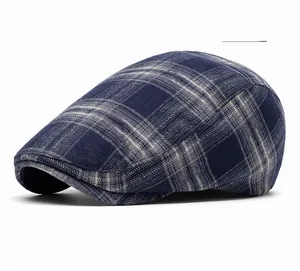 Detail shot of navy blue plaid fabric texture and fine stitching on a vintage newsboy cap