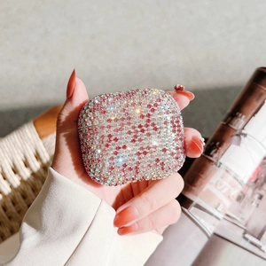 Detail of pink and iridescent rhinestones on a sparkling square AirPods protective case
