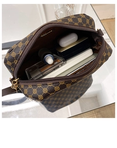 Top view of compact crossbody camera bag showing spacious interior with personal essentials