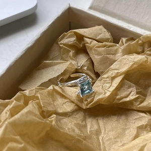 Detailed shot of S925 silver ring featuring blue square stone and lava texture finish