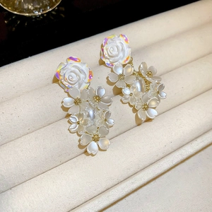 Elegant white floral drop earrings with shimmering 3D petals and golden bead accents