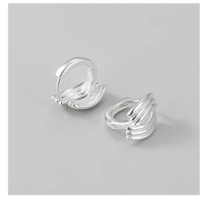 Macro detail of S925 sterling silver multilayered line earrings with high polish finish