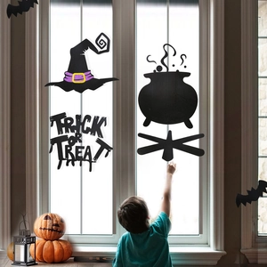Detail of Halloween window decals featuring a witch hat and child reaching for a cauldron