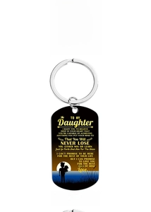 Detail view of black stainless steel dog tag keychain with printed quote for daughter