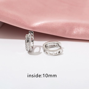 Macro view of silver earrings with double row cubic zirconia and 10mm inner diameter