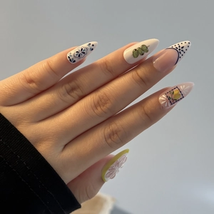 Mediterranean-style almond fake nails with blue floral, lemon, and olive motifs