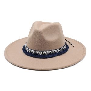 Detailed side view of khaki wide brim fedora with ethnic beaded band and blue tassels
