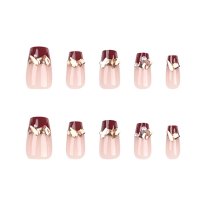 French burgundy and nude press-on nails with glitter rhinestones and pearls on white background