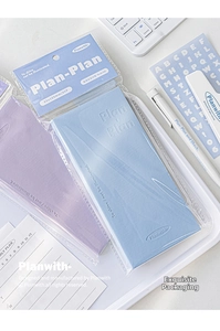 Detailed view of PU leather daily planners in blue and purple in a workspace set