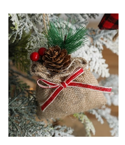 Linen Christmas gift bag ornament with pinecones and red berries on snowy tree branch
