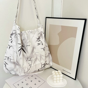 Large paisley canvas tote bag in white and black floral patterns with a shoulder strap