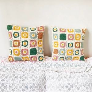 Handmade granny square crochet pillow covers with colorful floral patterns for sofa decor
