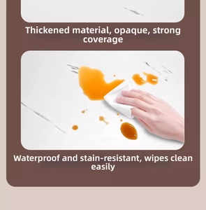 Close-up of waterproof marble kitchen sticker being wiped clean with a paper towel