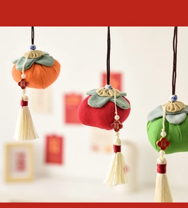Detail of fabric persimmon ornaments with Fu character pendants and cream tassels