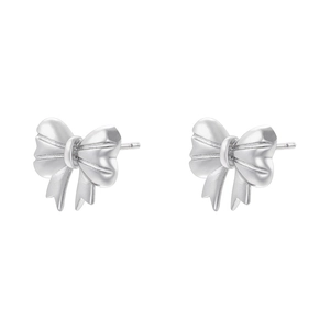 Close-up detail of silver bow-shaped stud earrings with elegant metallic texture