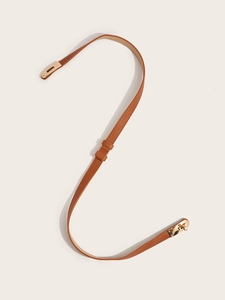 Detail of caramel cross-grain leather belt with gold metal twist lock buckle closure