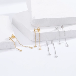 Detailed close-up of S925 silver flower tassel earrings with zircons on stone background