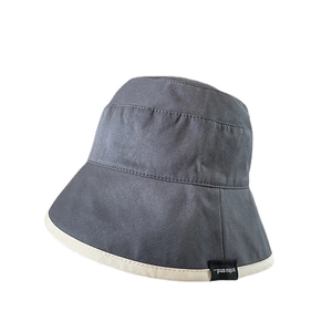 Double-sided cotton bucket hat in dark grey and beige with a small side woven label
