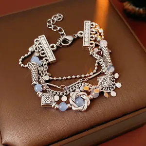 Vintage layered silver alloy bracelet with geometric charms and blue beads