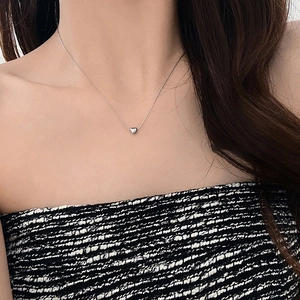 Minimalist silver heart pendant necklace with polished finish on a delicate chain