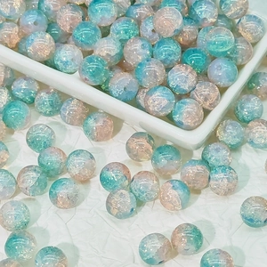 Detailed macro view of 10mm cracked glass beads with blue and orange gradient for DIY jewelry