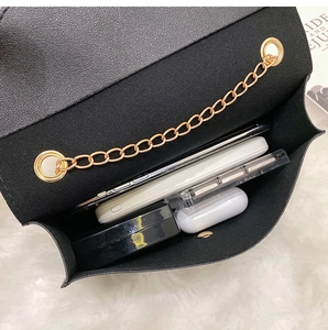 Top view of compact black chain crossbody bag showing large storage capacity and interior