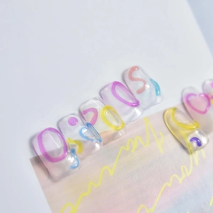 Close-up of clear jelly nail art stickers with colorful neon waves and abstract patterns