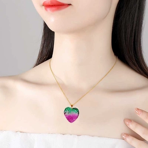 Crystal heart pendant necklace with green and pink gradient on a gold chain